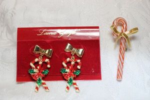 lot 271 image: Enamel bow and candy cane poststud dangle earrings on Laura Gayle (Ohio, 1997-2001) branded card. 2L Includes a glass candy cane pin