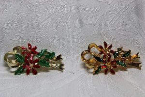 lot 267 image: (2) Holly & Berry bow broochpins. Includes a signed Gerrys pin. Marked Gerrys on reverse. 2H. Includes a second unbranded Holly & berry themed brooch. 2H
