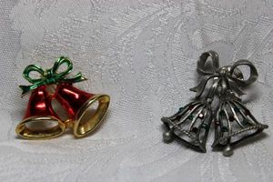 lot 270 image: (2) Enamel red and green bell broochpin and pewter colored crystal decorated bell lapel pin. Both about 1.5W