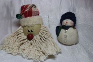lot 257 image: (2) Fabric broochpins. Santa 5L x 3.5W (Marked Debbie 92) and 1998 Judy Holland (Collectable Creations, Portland, OR) signed snowman 2.75H x 2W