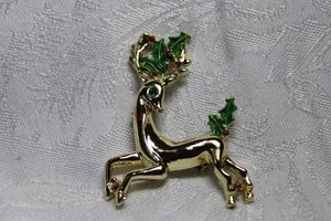 lot 262 image: Signed Gerrys 3 dimensional reindeer broochpin with holly and berries. Marked Gerrys on reverse. 2H x 1.75W