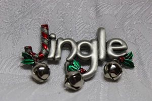 lot 243 image: Figural Jingle broochpin in pewter color with enamel accents and dangle bells. 2.50W x 2H