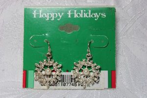 lot 240 image: Rhinestone and faux pearl ear wire earrings in snowflake form on card. 1.25L