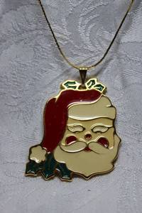 lot 254 image: Signed Wallace Silversmiths enamel Santa face pendant on 18L box chain with spring ring clasp. Marked on reverse  Wallace Silversmiths.Large bale. 2.25H x 2W