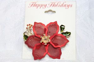 lot 239 image: Enamel and red metal mesh poinsettia flower broochpin on branded Table & Tower (Kohls) card. 2H x 2.25W