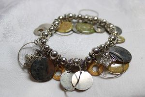 lot 236 image: Modernist metal circle stretch bracelet with snowflake charms.