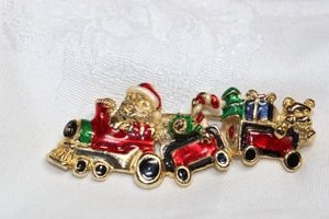 lot 233 image: Santa enamel broochpin with train cars and toys. 2.75L