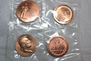 lot 206 image: Rose gold colored commemorative coins - (2) Missing while serving You are not forgotten,  (1) Roosevelt Conservation coin, (1) Abraham Lincoln coin