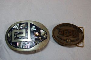 lot 196 image: Mother of Pearl inlay belt buckle with Mexico sticker, Brass Safe Driver Award apac belt buckle