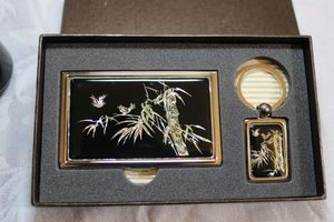 lot 195 image: Mother of Pearl inlaid set with key chain and business card holder. Tree with birds design.