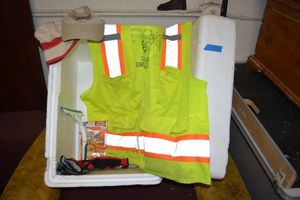 lot 149 image: Glow in the dark work vest, work gloves, hand warmers, window squeegee and hats with styrofoam cooler