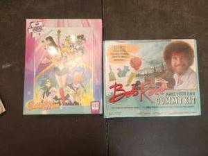 lot 232 image: Sailor Moon puzzle and Bob Ross gummy kit - unopened