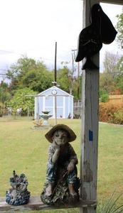 lot 207 image: Yard decorations - includes boy statue and pelican clock
