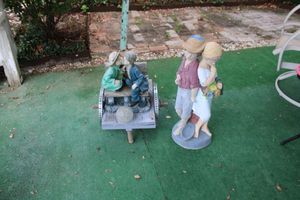 lot 204 image: Yard decorations - boy and girl statues
