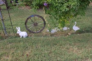 lot 216 image: Yard decorations - bunny statue, wagon  wheel, Duck silhouettes