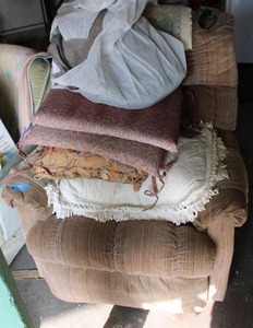 lot 167 image: Upholstered tan recliner with extra pillows and cushions