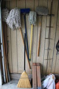 lot 161 image: Mops, broom, Wooden saw horses, extra broom handles, garden hose attachments and more