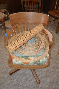 lot 16 image: Vintage wooden office chair with extra seat cushions, and cane seat materials. Chair is marked 15449