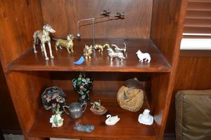 lot 20 image: Brass and pewter dog figurines, coconut monkey, animal figurines, decorated brass vase