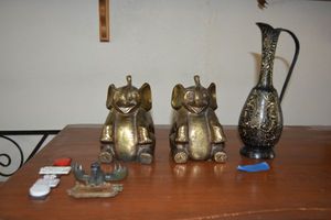 lot 47 image: Brass pitcher, pair of elephant bookends, and refrigerator magnets