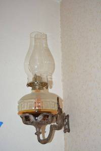 lot 50 image: Antique cast iron wall hanging oil lamp holder