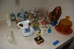 lot 65 image: Home dcor with amber glass candy dish, Avon bottles, blue glass bird and more