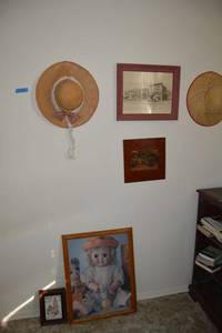 lot 96 image: Wall decorations - straw hats, Vintage Ford car pictures, completed puzzle pictures