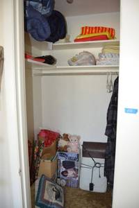 lot 112 image: Closet contents sleeping bag, comforter, Christmas wrapping paper, Seat massagers and more