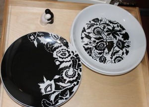 lot 63 image: Black and White Round Plates and salt and pepper shakers