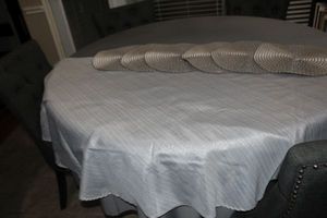 lot 100 image: Two silvergrey Round tablecloths and silver placemats