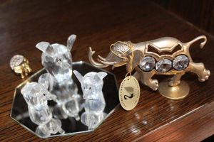 lot 34 image: Variety of Elephants 24K Gold Plated Elephant with Crystals, Facet Swarovski Crystal Elephant with Gold (plated) Head and Rear and Three Swarovski Elephants