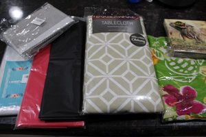 lot 109 image: Various Unused Table Coverings, Novelty Napkins, and more.
