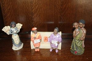 lot 153 image: Elements Merry Christmas Angel, Ebony Treasures Sunday Church Pew Collections, and Cornerstone Creations African Dance Figure