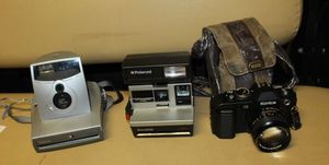 lot 226 image: Vintage Konica FS- 35 MM Film Camera, Appears to be in working Condition, Polaroid Sun 600, and Polaroid 1200 FF all Appear to be in Excellent Working Condition