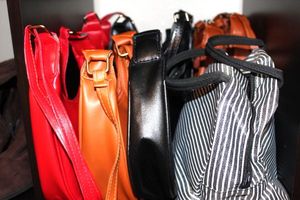 lot 184 image: Generous Quantity of Chinese Purses in three colors, and a lunch box with a stainless-steel food container.