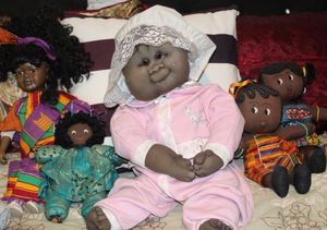 lot 116 image: Vintage Doll Collection Hand made Crying baby, Vintage Porcelain African American Collectors Doll and Two Vintage Gambini Dolls with Braids