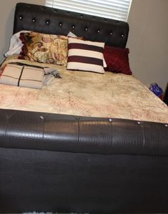 lot 163 image: Queen Size Bed, Head board, Base, Foot board and Bedding Shown (Sheet set, Comforter and Pillows) 2 throw Blankets. Mattress can go with