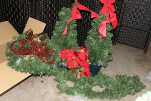 lot 213 image: Christmas Dcor, 2 Faux Trees, Wreath with Lights and ornaments and Garland, Red Bows and Merry Christmas Red Glittered Sign