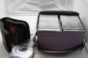 lot 222 image: Case of CDs and portable cd player and case