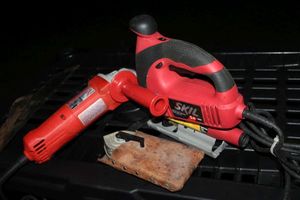 lot 70 image: Very Lightly Used Skil Jig Saw And Milwaukee 4 inch Grinder with Chalk line