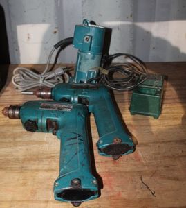 lot 130 image: Two Makita Battery powered Drills and Charger (no Batteries) and Corded Router