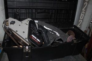 lot 188 image: Large Porter Cable Belt Sander in Plastic Storage Box and Sand Paper