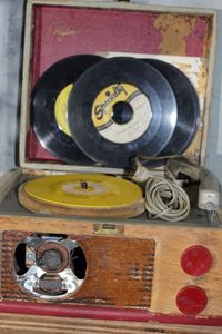 lot 107 image: Vintage Play tune Record Player and Assortment of 45 Records