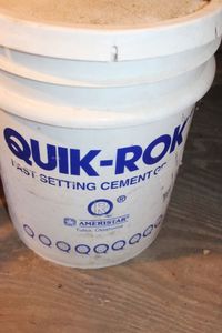 lot 243 image: Half  bucket of Fast Setting Cement