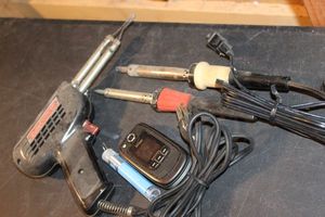 lot 300 image: Weller Soldering Iron, Verizon Samsung Flip Phone, and Two other Soldering tools