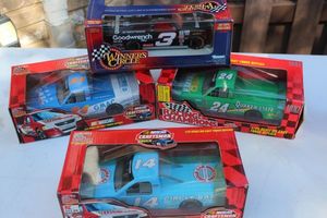 lot 72 image: Three Collectable Nascar Die Cast Truck Replica, #14 Circle Bar Motel Rick Crawford, #24 GMAC Jack Sprague, #24 Quaker State Truck Jack Sprague and 1997 Winners Circle Jay Sauter $3 GM Goodwrench