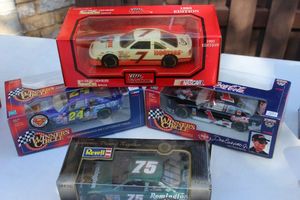 lot 73 image: Four Collectable Die Cast cars, Alan Kulwicki #7 Hooters Winners Circle 1998 Dale Earnhardt JR #1 Coca-Cola, Winners Circle Jeff Gordon #24 Superman Racing, and Revell Racing #75 Remmington Ford Thunderbird 1997