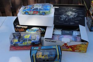 lot 74 image: Four Collectable Die Case Cars, Wardon Burton Pontiac Grand Prix Fundraiser Edition, Revell 1997 Chevrolet Nascar Dale Earnhardt Jr. Wrangler, Mark Martin Winn Dixie Nascar, and 2003 Racing Champions Jimmie Johnson Lowes