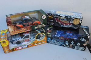 lot 75 image: Four Collectable Die Cast Trucks Ertl Collectables1940 Ford Modified Coupe, 1949 Oldmobile Rocket, Racing Champions Blue Kiss Pontiac Hot Rockin and Rick Crawford #14 Powerstoke Ford Diesel