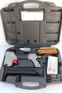 lot 99 image: Porter cable Nail gun with case